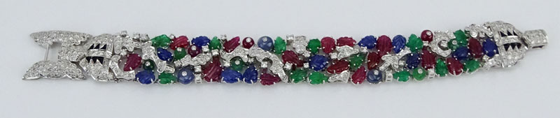 Cartier style 55.50 Carat Carved Emerald, Ruby and Sapphire and 9.15 Carat Round Brilliant Cut Diamond and 18 Karat White Gold Tutti Frutti Bracelet. 