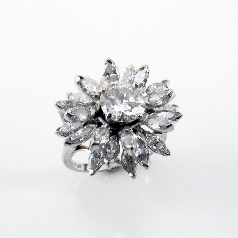 Circa 1950s Approx. 5.0 Carat TW Diamond and Platinum Cluster Ring set in the Center with a 1.33 Carat Round Brilliant Cut Diamond and accented with 24 Marquise Cut Diamonds