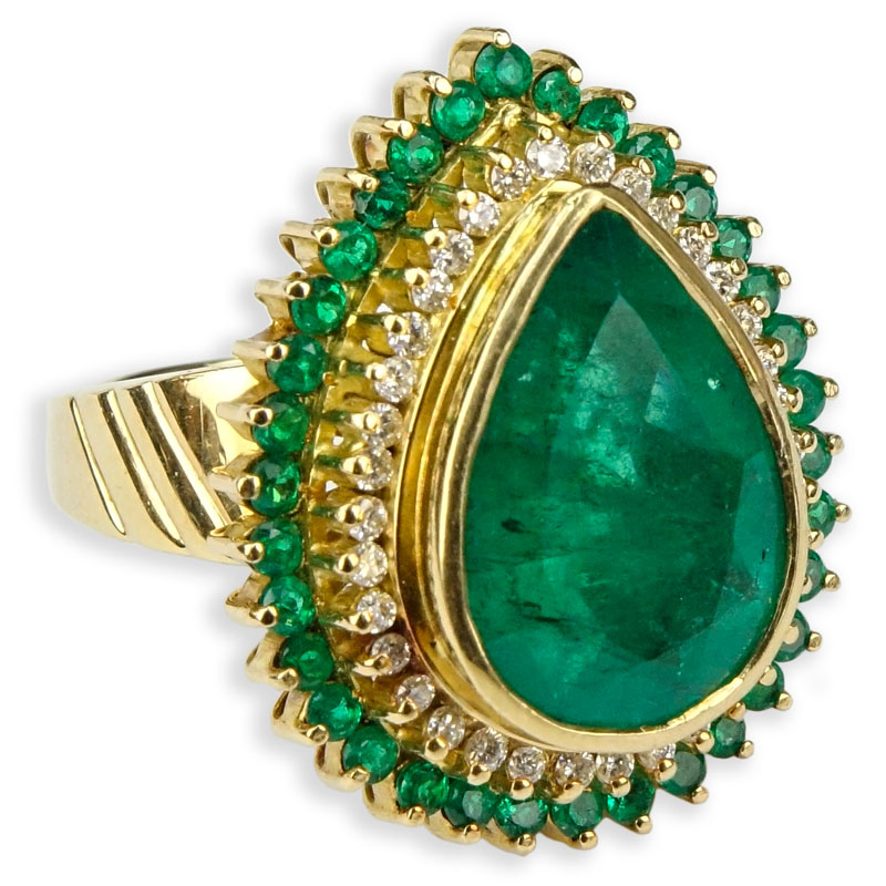 7.50 Carat Pear Shape Colombian Emerald and 18 Karat Yellow Gold Ring accented with .50 Carat Round Brilliant Cut Diamonds and 2.0 Carat Round Cut Emeralds.