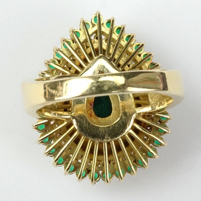 7.50 Carat Pear Shape Colombian Emerald and 18 Karat Yellow Gold Ring accented with .50 Carat Round Brilliant Cut Diamonds and 2.0 Carat Round Cut Emeralds.