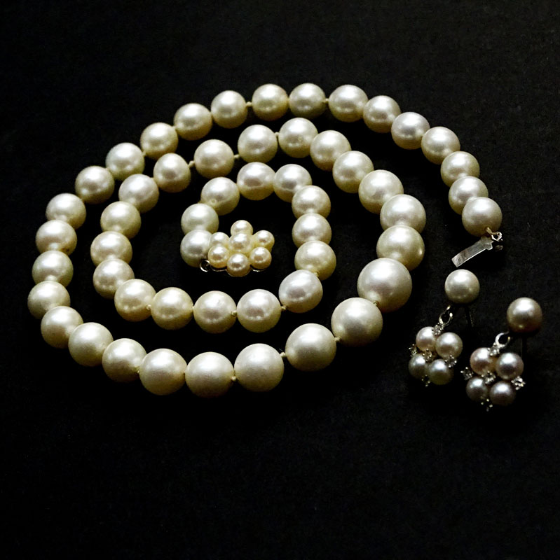 Vintage Single Strand 7.5mm-10.0mm White Pearl Necklace with 14 Karat White Gold Clasp and with Matching Earrings Accented with Small Round Cut Diamonds.