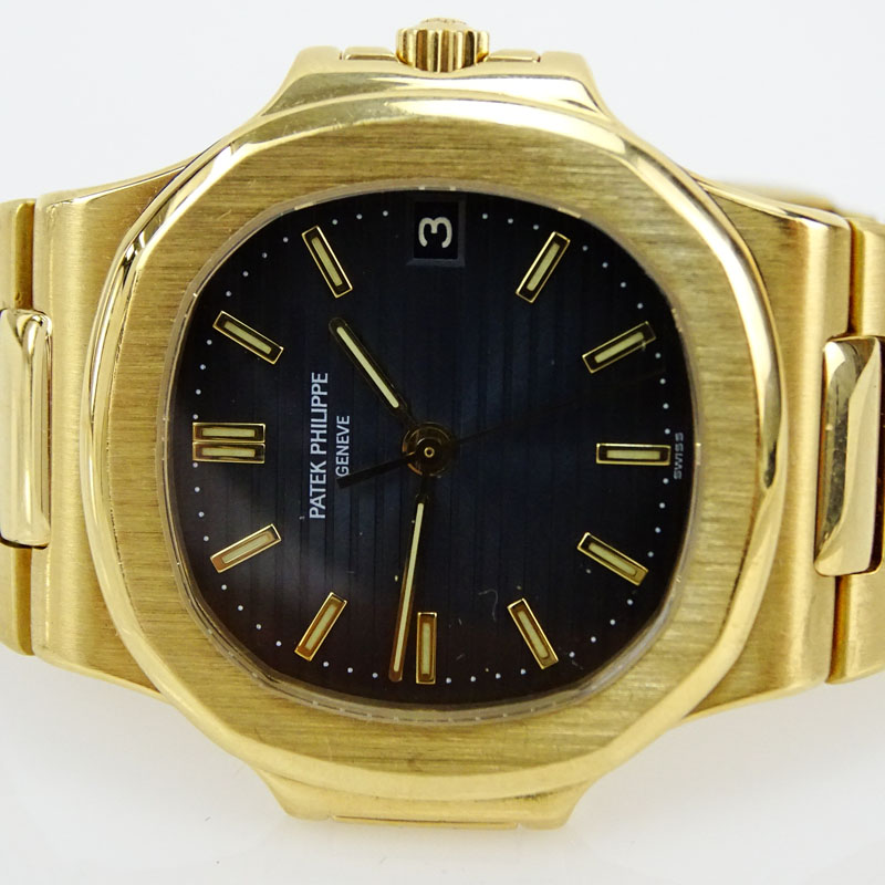 Man's Patek Philippe Nautilus 18 Karat Yellow Gold Automatic Movement Watch with Black Dial