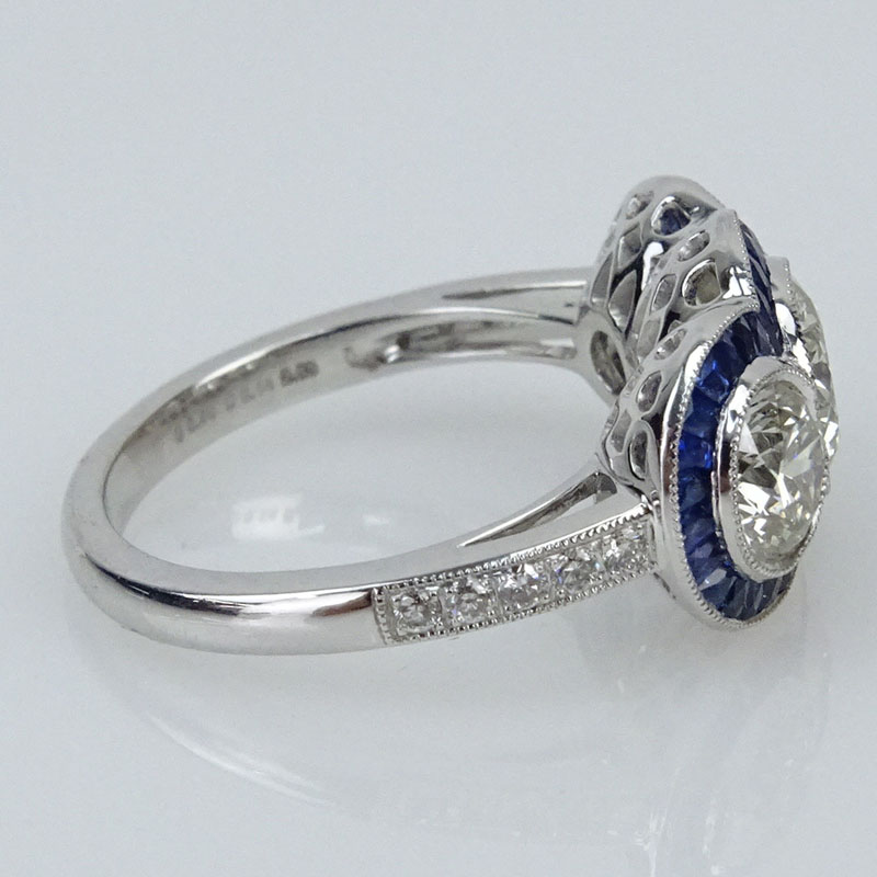 2.67 Carat Round Brilliant Cut Diamond and Platinum Three Stone Ring accented with .88 Carat French Cut Sapphires.