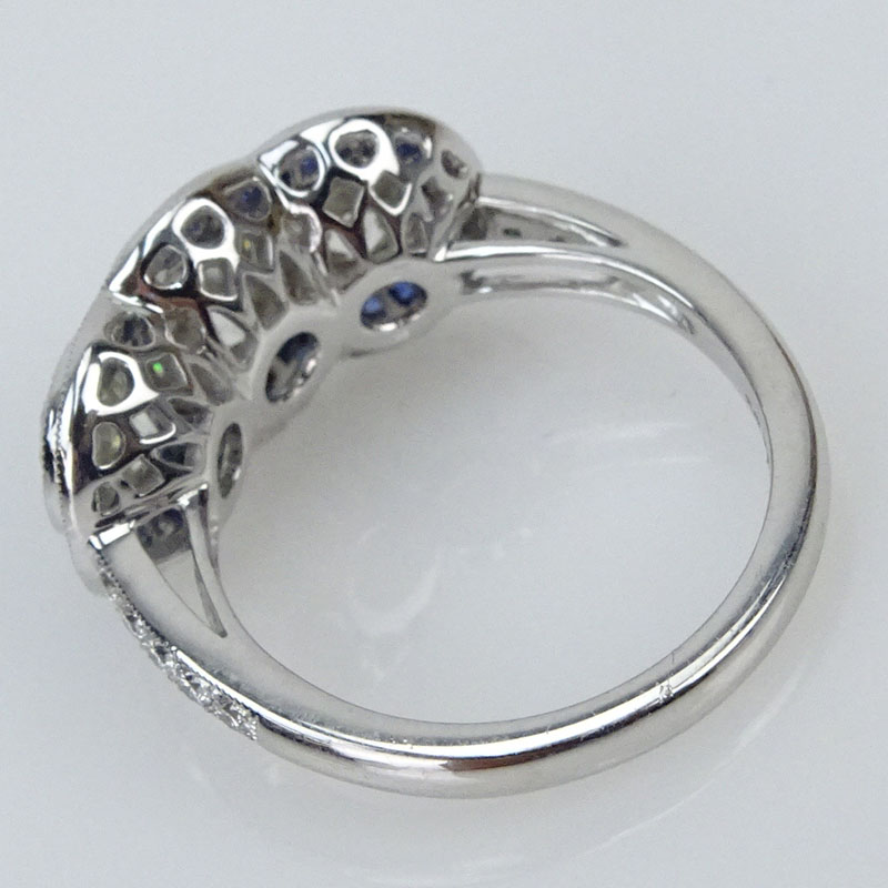 2.67 Carat Round Brilliant Cut Diamond and Platinum Three Stone Ring accented with .88 Carat French Cut Sapphires.