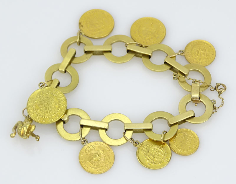 Vintage 18 Karat Yellow Gold Charm Bracelet with Seven Gold Coins Including Cuban, Mexican, Peruvian and Spanish Coins and a Reclining Man Charm