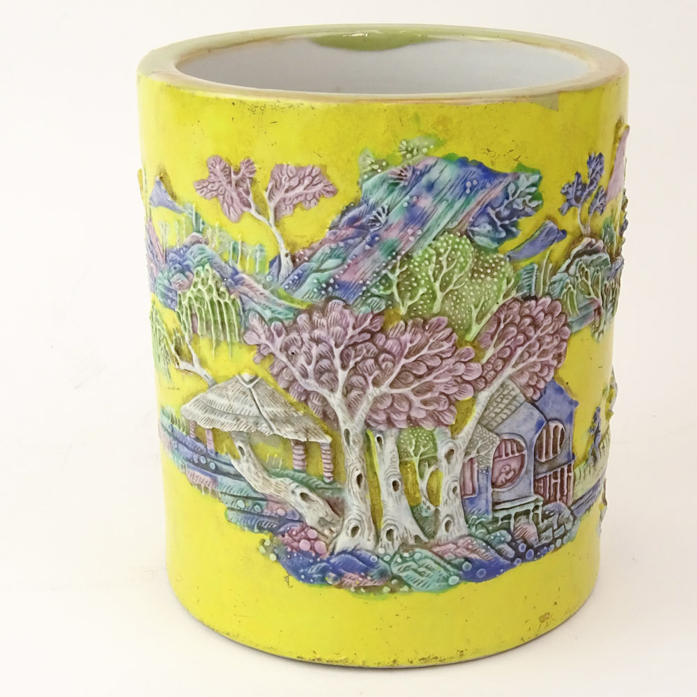 Chinese Guangxu (1875-1908) Famille Jaune Porcelain Brush Pot with Molded Relief Decoration Depicting a Mountain Village Landscape