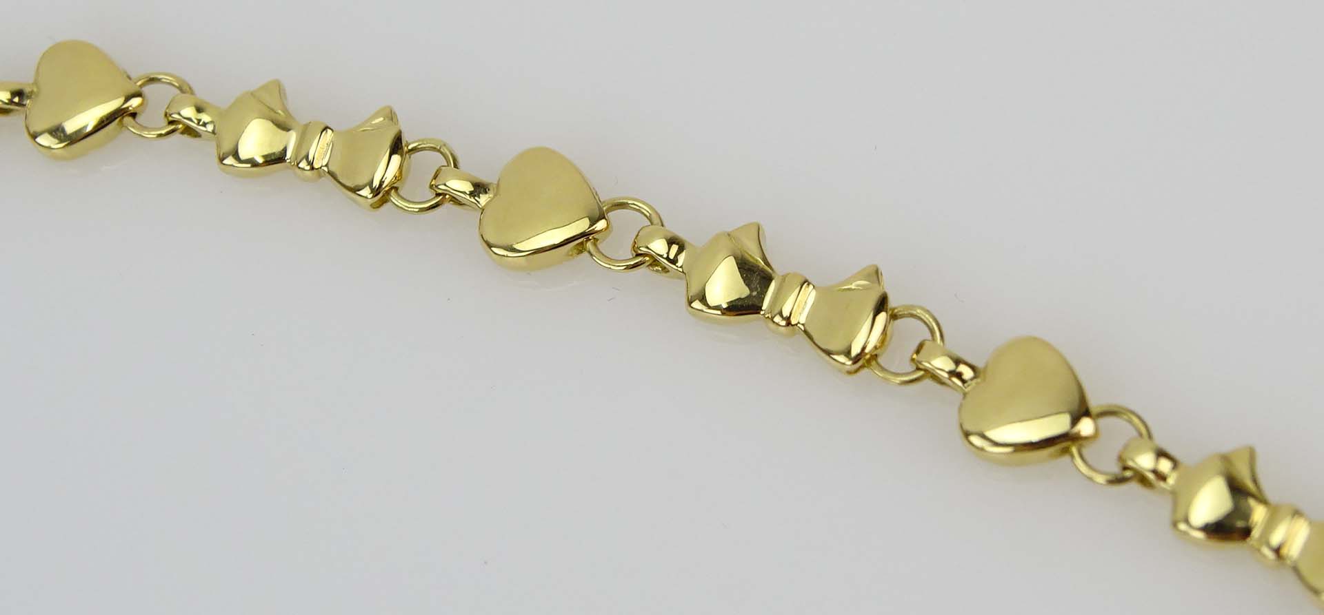 Tiffany & Co 18 Karat Yellow Gold Hearts and Bow Tie Necklace.