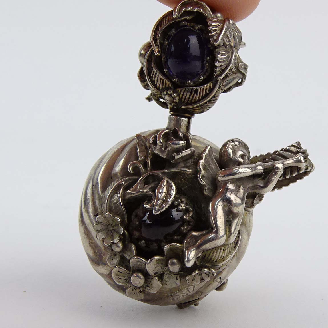 Art Nouveau style Sterling Silver Pendant Scent/Snuff Bottle with Amethyst and Garnet Accents; 935 Silver and Marcasite Chariot Brooch; English Sterling Silver Brooch Frame; American 950 Silver and Onyx Pendant and Russian Painted Shell Brooch.