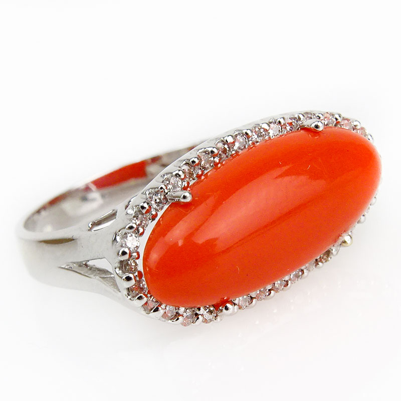 Oval Cabochon Red Coral, .40 Carat Diamond and 18 Karat White Gold Ring. 