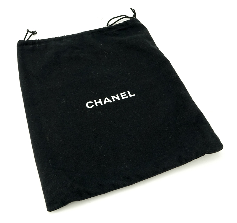 Chanel Black Lambskin Flap Bag. Silver tone hardware, "Chanel" fabric interior with zipper pocket. 