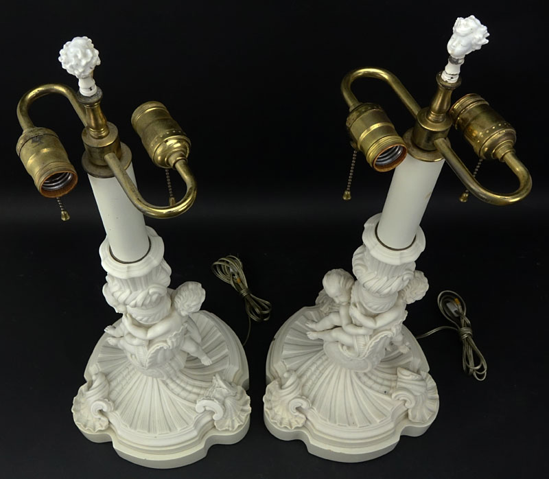 Pair of 19/20th Century Sevres Style Bisque Cherub Figural Lamps with Cherub Finials.