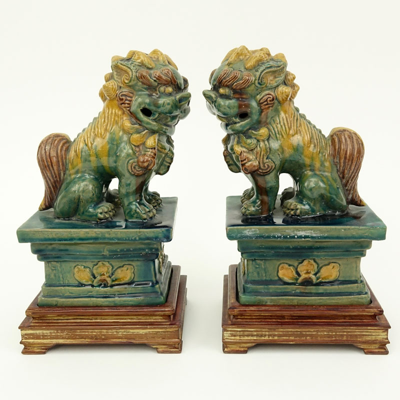 Pair Chinese Sancai Glaze Pottery Foo Dog Figures on Wood Bases.