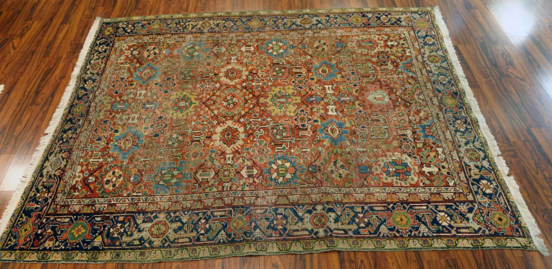 Large Semi Antique Heriz Rug. Worn, some discoloration, dirty, and has been re-fringed.