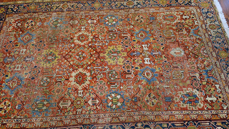 Large Semi Antique Heriz Rug. Worn, some discoloration, dirty, and has been re-fringed.