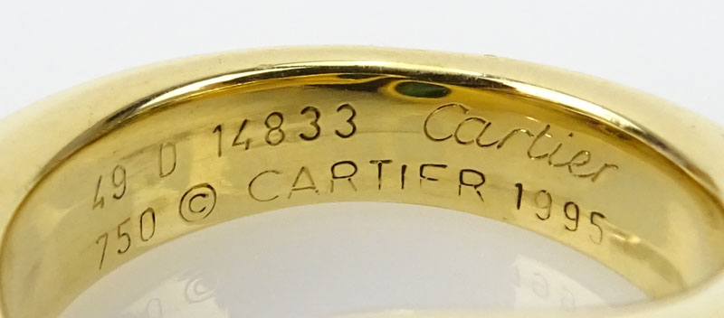 Vintage Cartier Approx. 1.0 Carat Oval Cut Emerald and 18 Karat Yellow Gold Ellipse Deux Tetes Croisees Bypass Ring.