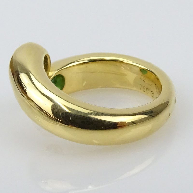 Vintage Cartier Approx. 1.0 Carat Oval Cut Emerald and 18 Karat Yellow Gold Ellipse Deux Tetes Croisees Bypass Ring.