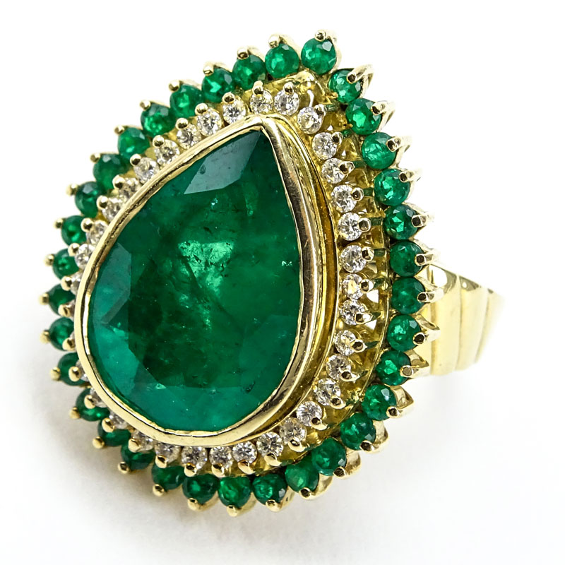 Approx. 7.50 Carat Pear Shape Colombian Emerald and 18 Karat Yellow Gold Ring Accented throughout with Approx. .50 Carat Diamonds and 2.00 Carat Emeralds.