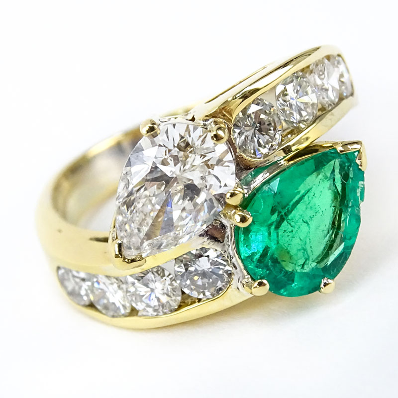 Vintage Approx. 1.18 Carat Pear Shape Diamond, 1.50 Carat Pear Shape Colombian Emerald and 18 Karat Yellow Gold Ring Accented with 1.50 Carat Round Brilliant Cut Diamonds. 