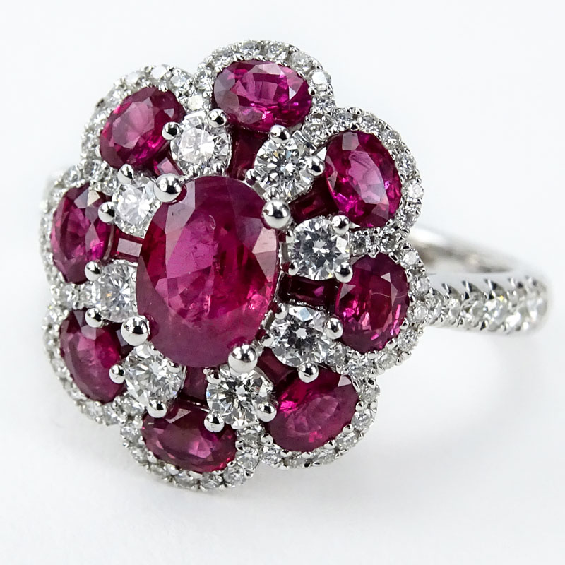 Approx. 2.08 Carat TW Oval Cut Ruby, .65 Carat Round Brilliant Cut Diamond and 18 Karat White Gold Ring, set in the Center with a 1.23 Carat Oval Cut Ruby. 