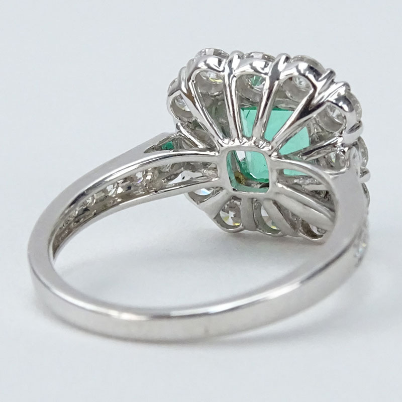 Approx. 1.55 Carat Round Brilliant Cut Diamond, Square Cut Emerald and 18 karat White Gold Halo Ring. 