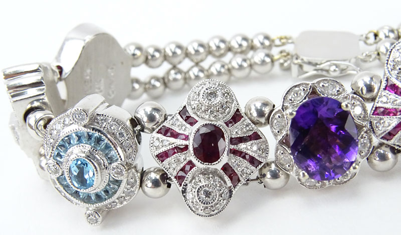 Vintage R. Klein 14 Karat White Gold and Diamond, Ruby, Sapphire, Amethyst and Blue Topaz Charm Bracelet. 
