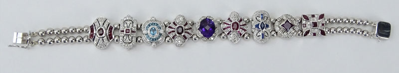 Vintage R. Klein 14 Karat White Gold and Diamond, Ruby, Sapphire, Amethyst and Blue Topaz Charm Bracelet. 