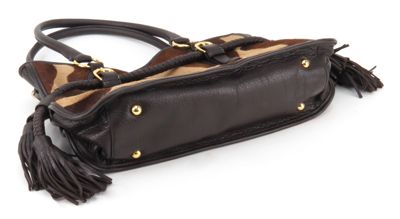 Adrienne Vittadini Cowhide and Leather Bag. Satin interior with zipper and slot pockets, magnetic closure. Marked appropriately.
