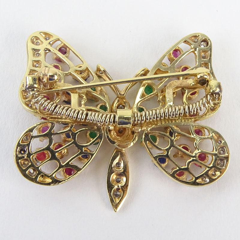 Vintage 14 Karat Yellow Gold Articulated Butterfly Brooch set with Diamonds, Rubies, Emeralds and Sapphires.