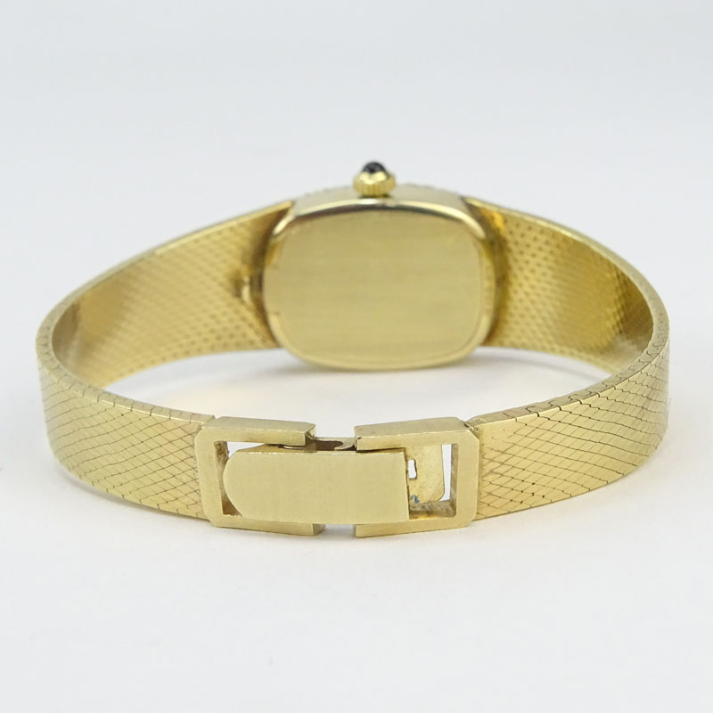 Lady's Vintage Movado 14 Karat Yellow Gold Bracelet watch with Diamond Bezel and with Swiss 17 Jewel Zenith Manual Movement.