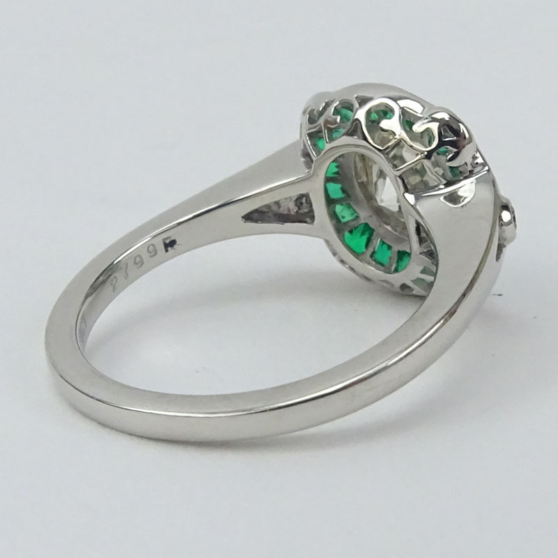 Approx. 1.10 Carat Round Brilliant Cut Diamond, .63 Carat Calibre Cut Emerald and Platinum Ring. .