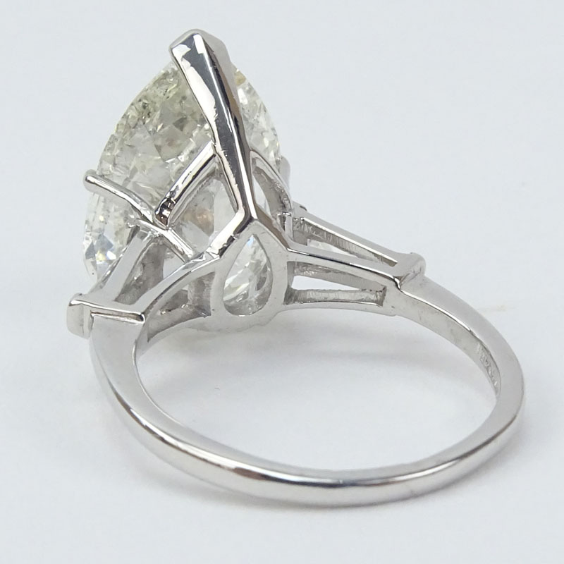 Approx. 6.32 Carat Pear Shape Diamond and Platinum Engagement Ring accented with .50 Carat Tapered Baguette Diamond. .