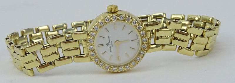 Lady's Vintage Baume & Mercier Genève 14 Karat Yellow Gold Bracelet Watch with Diamond Bezel.