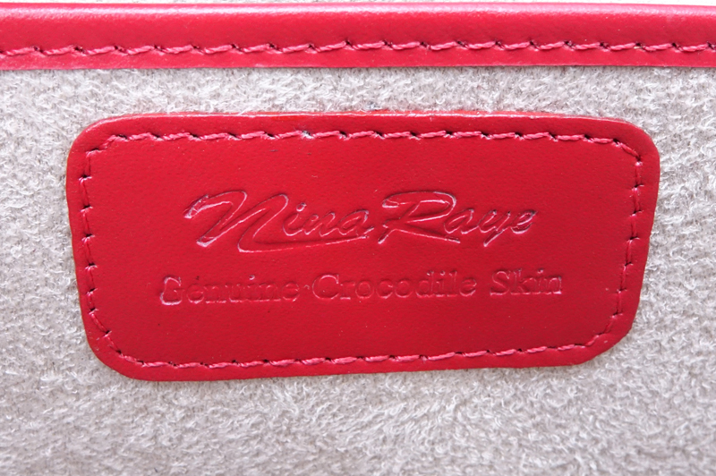 Nina Raye Red Crocodile Satchel. Suede interior with numerous pockets. Magnetic closure.