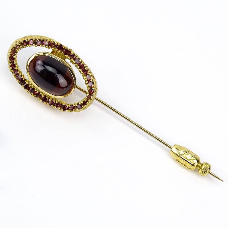 Vintage Garnet and 14 Karat Yellow Gold Stick Pin Set in the Center with an Oval  Cabochon Cut Garnet Measuring 13mm x 9mm. Unsigned.