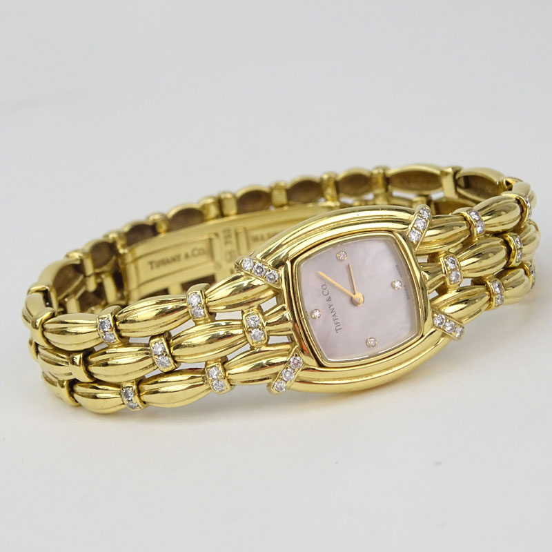 Tiffany & Co 18 Karat Yellow Gold and Diamond Signature Bracelet Watch, Mother of Pearl Dial, Swiss Automatic Movement. 
