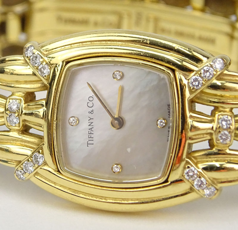 Tiffany & Co 18 Karat Yellow Gold and Diamond Signature Bracelet Watch, Mother of Pearl Dial, Swiss Automatic Movement. 