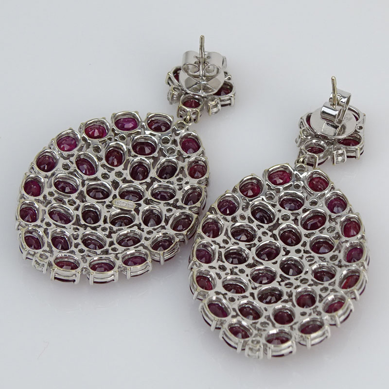 Contemporary Approx. 37.53 Carat Oval Cut Ruby, 2.05 Carat Round Brilliant Cut Diamond and 18 Karat White Gold Pendant Earrings. 