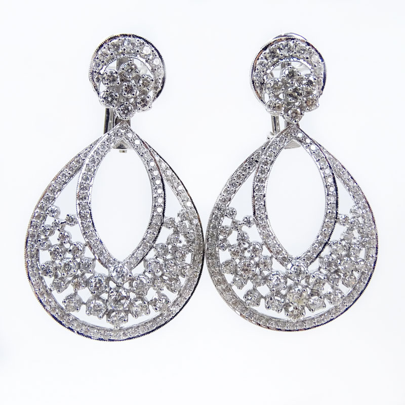 Van Cleef & Arpels style Approx. 7.24 Carat Round Brilliant Cut Diamond and 18 Karat White Gold Pendant earrings.