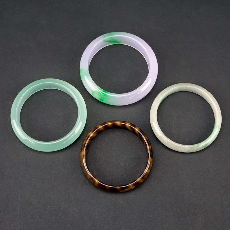 Collection of Four (4) Chinese Carved Jadeite Bangles.