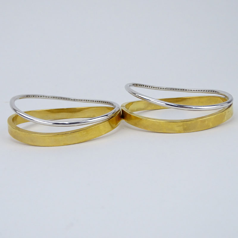 Pair of Pave Set Diamond, 18 Karat White and Yellow Gold Hinged Bangle Bracelets. 