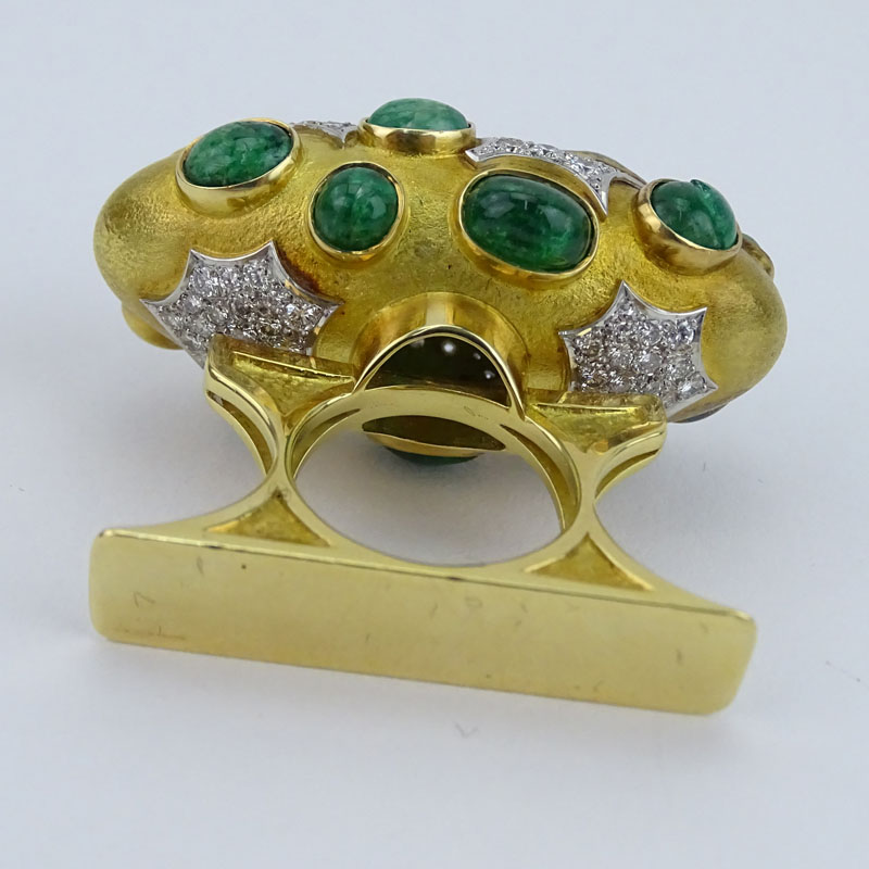 Circa 1968 Roger Lucas (20th century) Montreal, Canada Approx. 16.0-18.0 Carat Sixteen (16) Cabochon Colombian Emerald, 5.5-6.0 Carat Pave Set Diamond and Heavy 18 Karat Yellow Gold Three Finger Ring. 