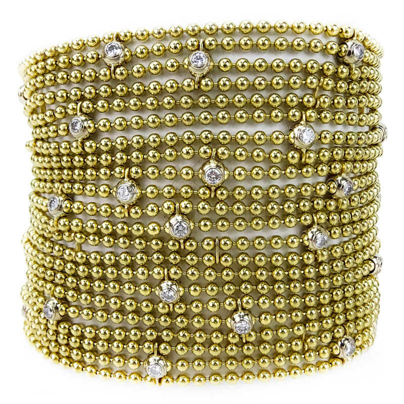 Cartier Round Brilliant Cut Diamond and 18 Karat Yellow Gold Multi Strand Bead Bracelet with original Cartier Box en suite with the previous lot.