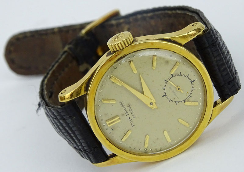 Vintage Patek Philippe 18 Karat Yellow Gold Manual Movement Watch with Leather Strap and 18 Karat Yellow Gold Buckle.
