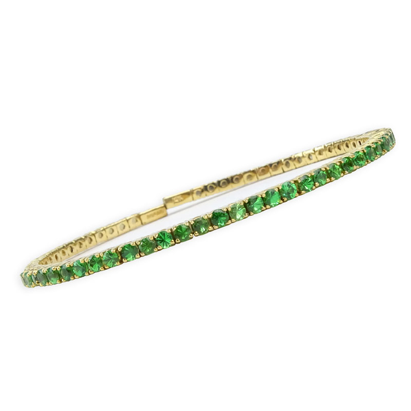 Vintage Round Brilliant Cut Emerald and 14 Karat Yellow Gold Flexible Cuff Bangle. Emeralds with vivid color.