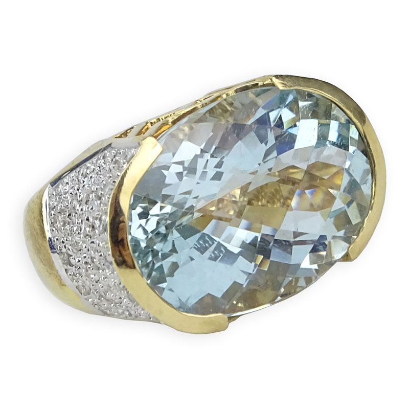Oval Criss Cross Cut Aquamarine, Pave Set Diamond and 14 Karat Yellow Gold Ring. 