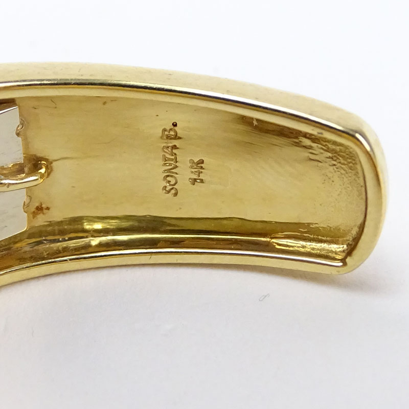 Vintage Sonia Britton 14 Karat Yellow Gold Hinged Bangle Bracelet with 10 Round Cut Diamond Accents.
