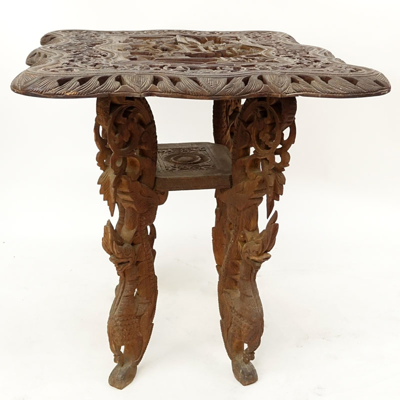 20th Century Thai Carved Teak Wood Table. Relief carving to top, pierced border, and stands on dragon figural legs. 