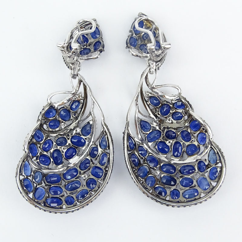 Approx. 40.0 Carat Pear Shape, Oval and Round Cut Sapphire and 18 Karat White Gold Earrings accented with approx. 1.20 Carat Round Brilliant Cut Diamonds. 