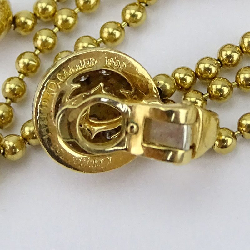 Circa 1999 Cartier Round Brilliant Cut Diamond and 18 Karat Yellow Gold Multi Strand Bead Necklace and Earring Suite