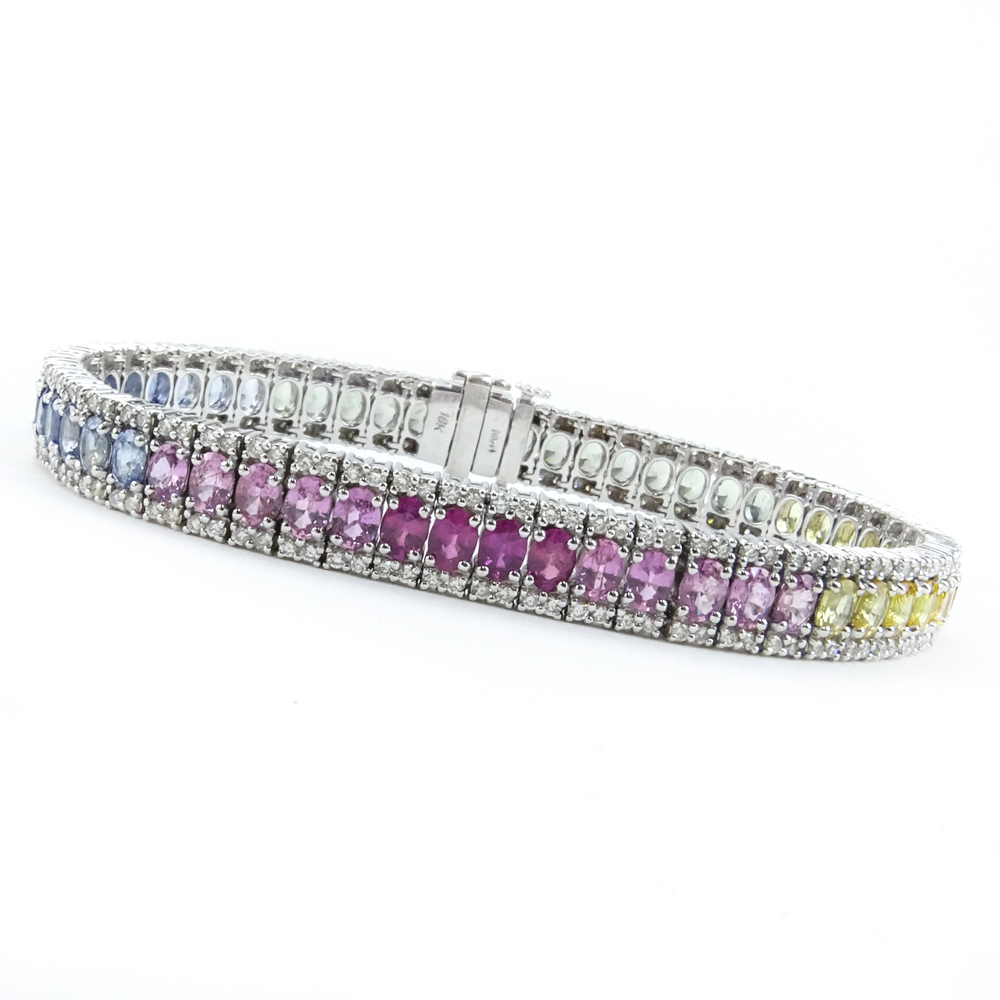  11.50 Carat Oval Cut Multi Color Sapphire, 2.25 Carat Diamond and 18 Karat White Gold Line Bracelet. Sapphires with vivid color. 